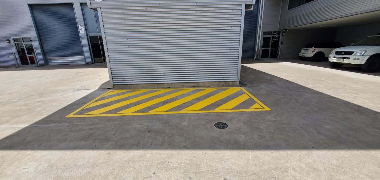 Yellow hazard box marking at a roller door